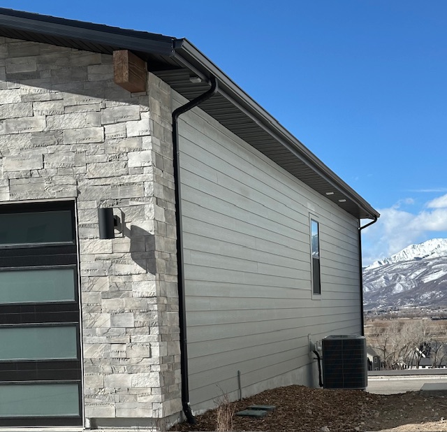 Home exterior 34 New home with a gutter system installed by Latimer Plastering LLC