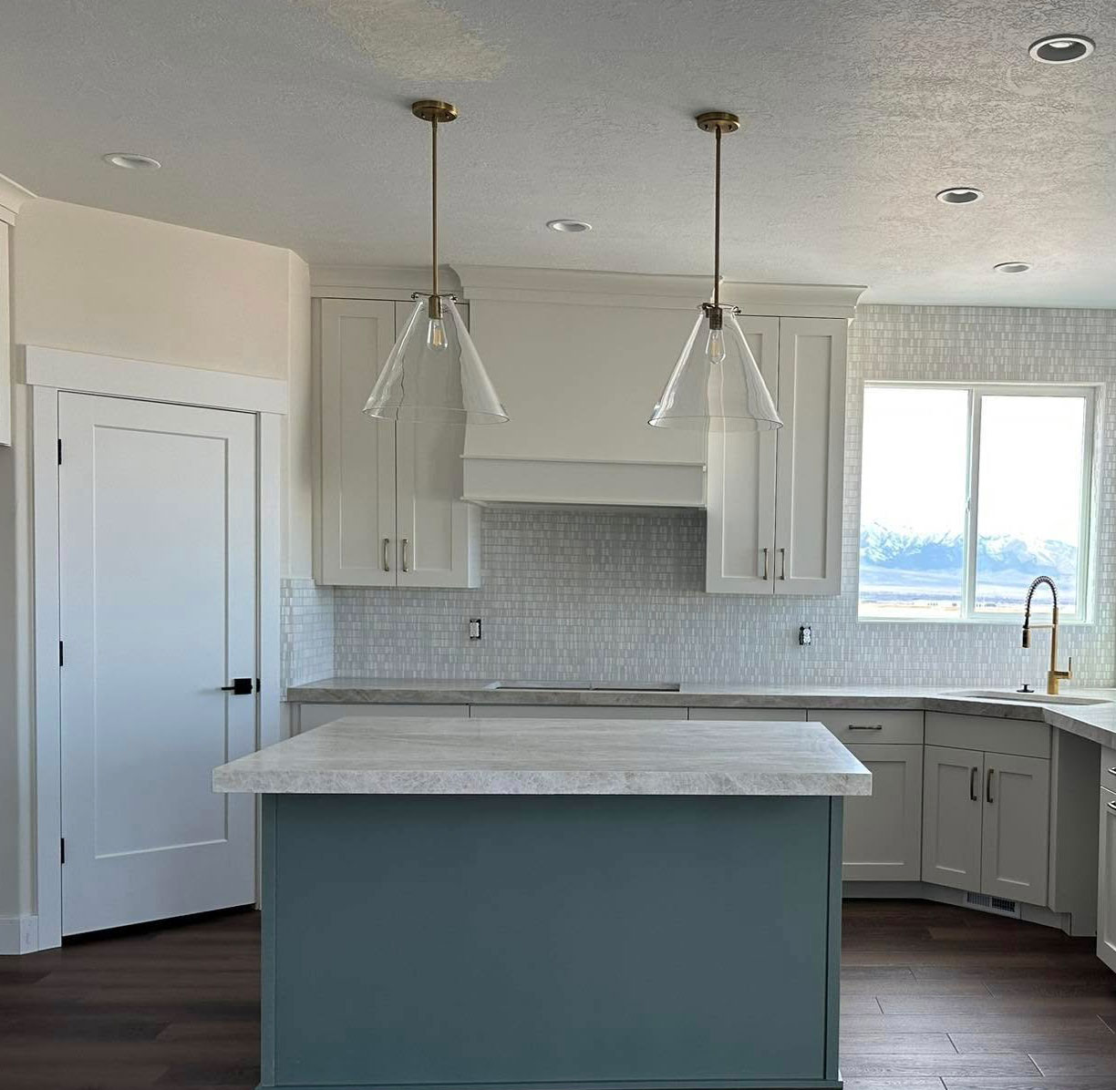 Kitchen-Lighting New Modern lighting hanging above an Island in a Kitchen