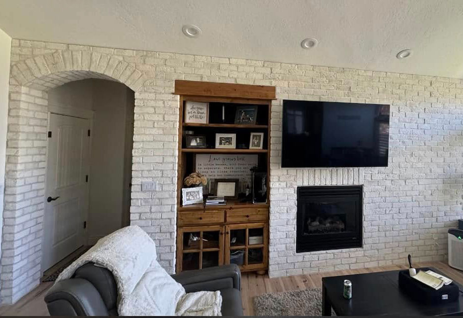 Living-room-witgh-brick-wall A living room with a white brick accent wall done by Latimer Plastering LLC