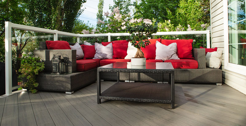 Red-Deck-patio-room Red Wicker furniture with cushions on dark grey outdoor patio deck