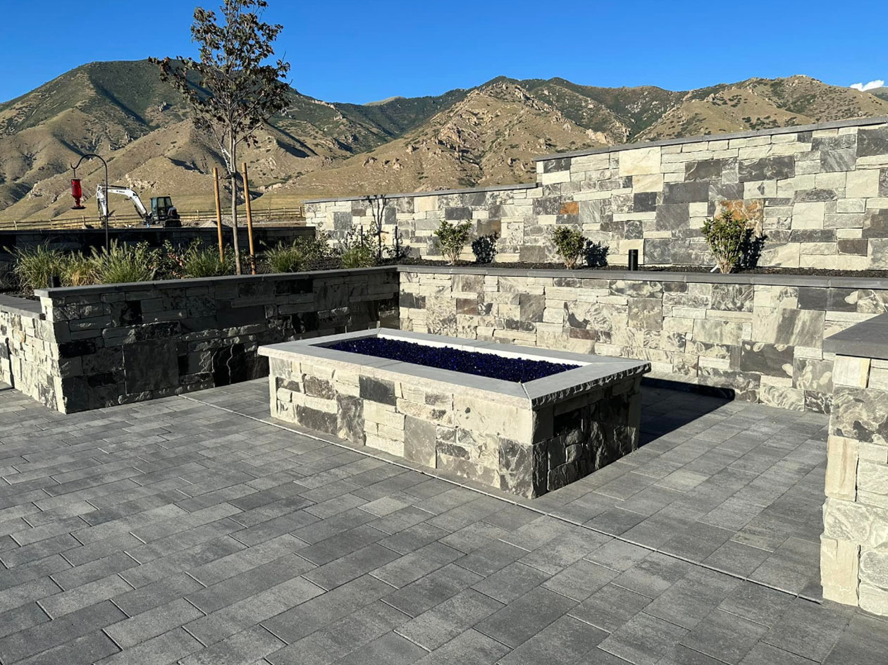 Stone-Masonry Stone Patio with retaining walls and raised fire pit.