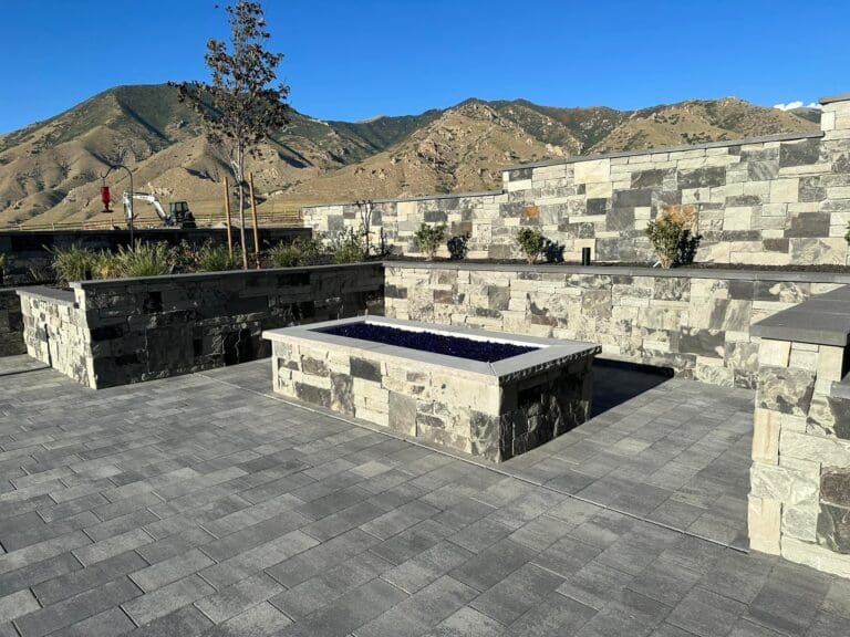 Stone patio with stone walls and raised fire pit Stone Patio with a raised fire pit