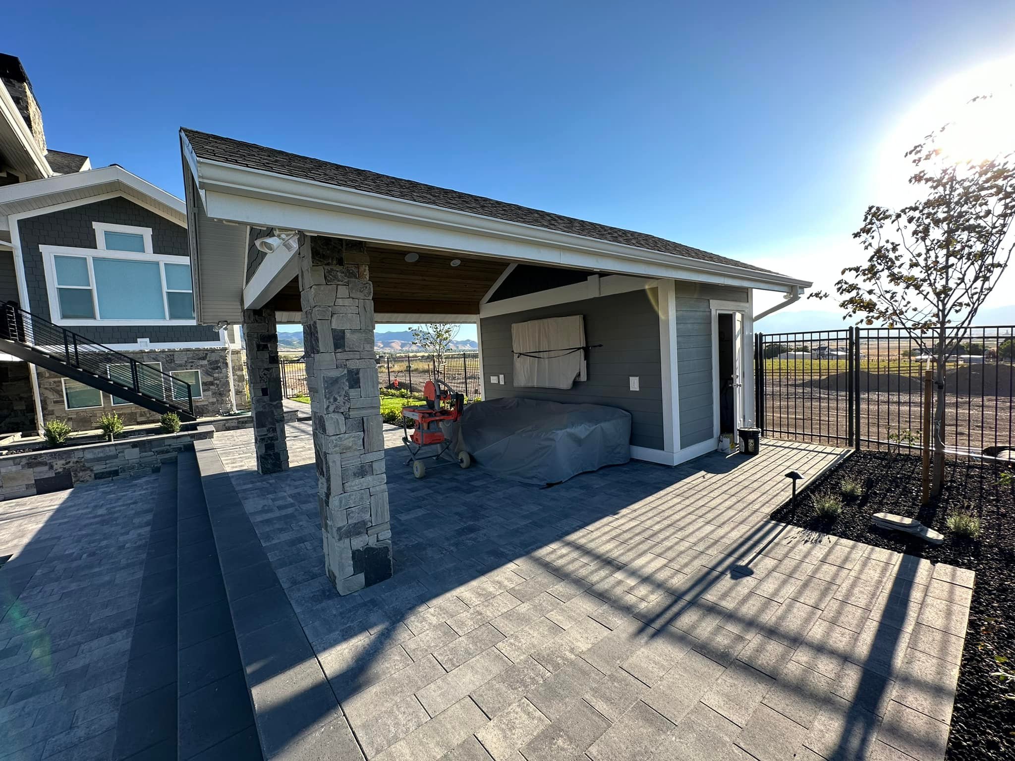 covered patio with storage area attached Covered stone patio by Latimer Plastering LLC