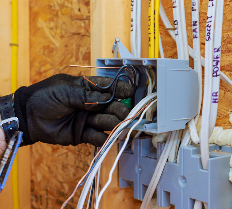 electrician-installing-wireing Electrician Installing wiring in a basement