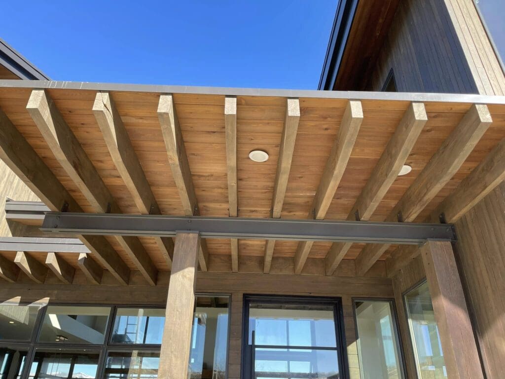 wood awning on home exterior Close up look at the stucco on the house